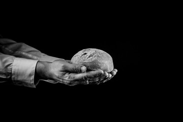 Man giving Bread. Helping Hand Concept. Copy space, Black and white
