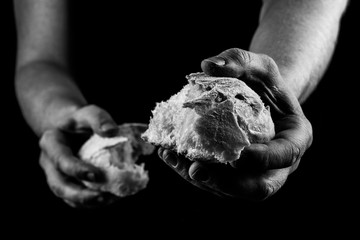 Helping hand giving a piece of bread. Man giving Bread, Helping Hand Concept. Black and white.