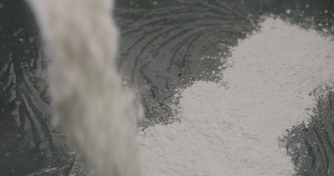Slow motion adding hardener to micro concrete plaster