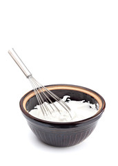 Whipped Cream with a Whisk on a White Background