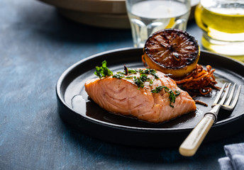 Salmon Sole Meuniere with lemon. Fillet of red fish. Steak trout fried with butter, lemon and parsley sauce