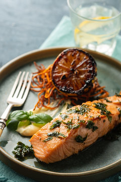 Salmon Sole Meuniere with lemon. Fillet of red fish. Steak trout fried with butter, lemon and parsley sauce