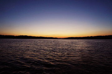 Obraz premium big vast lake water wiht colorful sunset