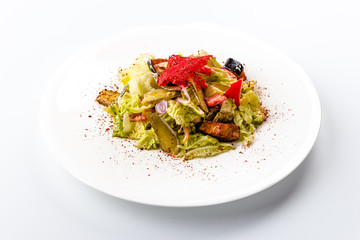 Vegetable salad with eggplant and red pepper. Isolated on white background.