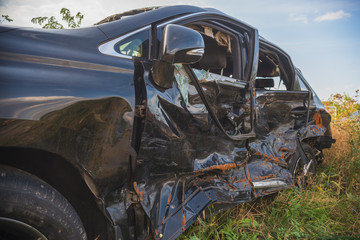 crashed doors of off-road car after the accident are on the sidelines