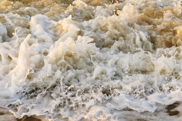 Fototapeta na wymiar Texture of the sea wave crashed against the shore