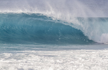 Beautiful light blue Ocean wave barrel breaking in Hawaii