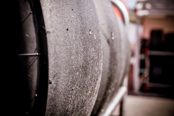 Slick car tires in a row close up