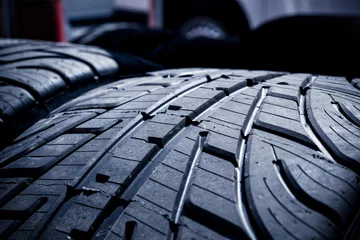 Zelfklevend Fotobehang Wet car tires tread grooves close up © fabioderby