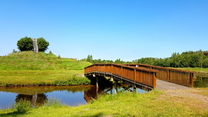 wooden bridge via river in summer morning