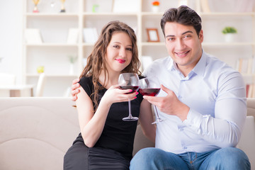Young pair drinking wine in romantic concept