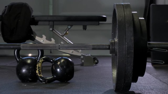 Dark moody 4k Footage of metal weights at home garage gym