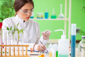 Beautiful female biotechnology scientist chemist working in lab