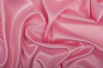 Pink satin fabric as background.