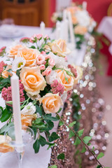 flower arrangement, crystal, glass candles decorate banquet hall