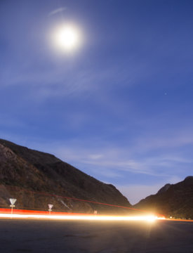 Long Exposure Traffic Light Trails through a mountain canyon at night with dark blue sky 2