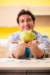 Fototapeta premium Young man husband in budget planning concept