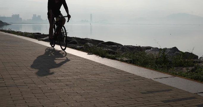  Silhouette of Couple Riding Bike on Seaside Road 