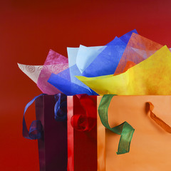 Colorful shopping bags with colorful wrappnig papers and ribbons