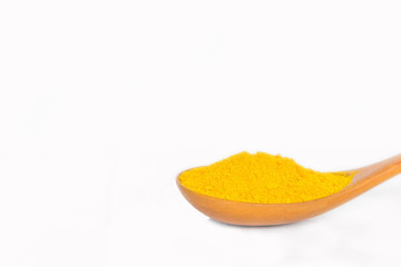 The soft focus turmeric powder on the wooden spoon, Zingiber,Turmeric root, Cassumunar ginger, Bengal root,Zingiberaceae,on the white background.Local food and Thai herb in Thailand.