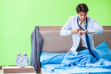 Fototapeta premium Employee in the bedroom being late for his job in time managemen