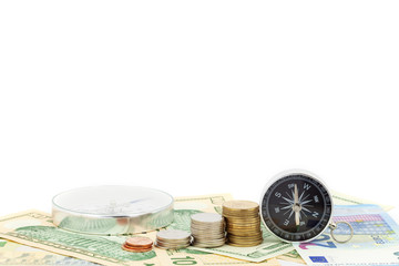 compass and coins on money banknotes Euro and Dollars,concept of business planning and finance and savings.