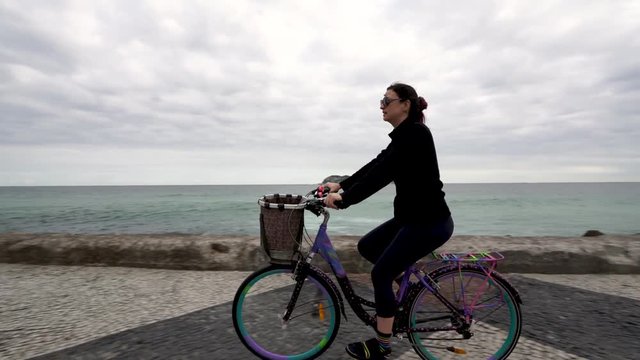 Cyclist Woman bicycle walk brazilian sea shore health fitness activity beach Rio de janeiro, Brazil