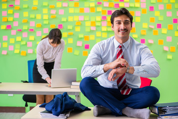 Man and woman in the office with many conflicting priorities in 