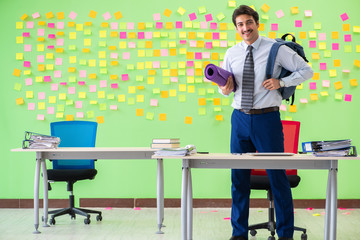 Man in the office with many conflicting priorities preparing go 