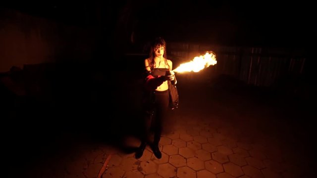 Beauty brazilian girl in abandoned beachwith spraycan on fire