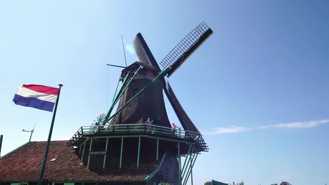 traditional windmills turning by wind sustainable clean energy, tourist attraction village Zaanse Schans near Amsterdam 