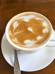 Hot coffee in a cup on wooden table
