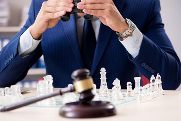 Young lawyer playing chess to train his court strategy and tacti