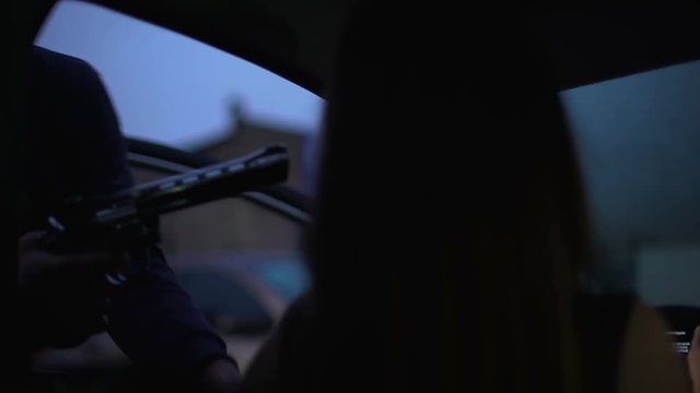 Carjacker threatening female victim with pistol, robber stealing automobile
