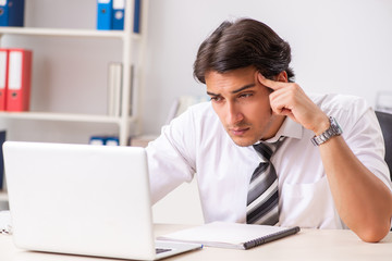 Young handsome businessman working in office