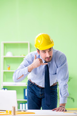 Young male architect working at the project