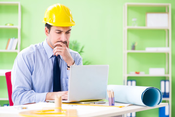 Young male architect working at the project