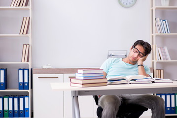 Young handsome student preparing for school exams