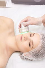 Obraz na płótnie Canvas Woman cosmetology procedure. Light face treatment. Medical skin repair. Anti wrinkle. Color skincare