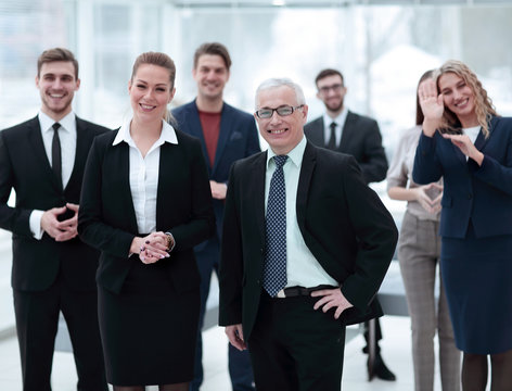 serious businessman and business woman on the background of the office staff.