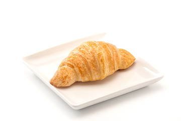 French croissants on wicker basket, bakery background