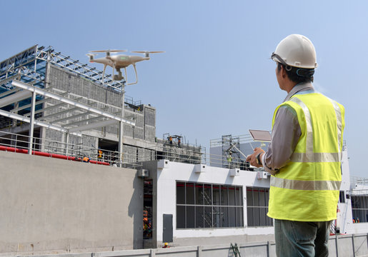 Drone inspection. Operator inspecting construction site control by civil engineer