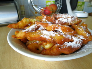 Baking with their hands-firewood dough, which is sprinkled with powdered sugar.