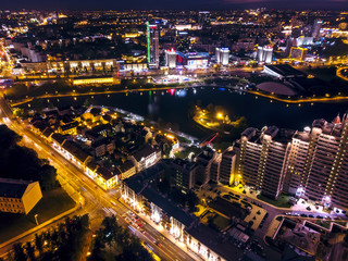 Picturesque night cityscape. Illuminated urban modern buildings, aerial top view. Minsk, Belarus