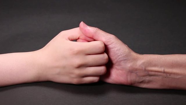 指相撲するシニアと若い女性