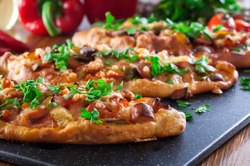 Traditional Turkish pide with meat and vegetables