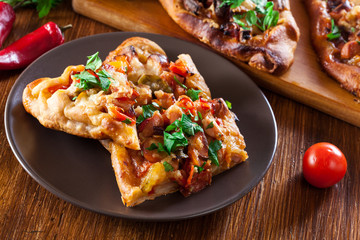 Sliced traditional Turkish pide with meat and vegetables