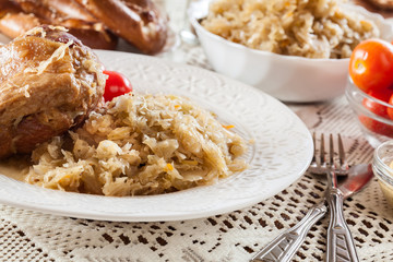Pork knuckle with fried sauerkraut and tomatoes