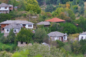 Fototapeta na wymiar Old houses in the historical cultural reserve village of Dolen, Bulgaria. Dolen is famous with its 350 old houses – an example of 19th century Rhodopean architecture.