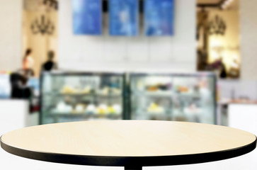 Selected focus empty brown wooden table and Coffee shop or restaurent blur background with bokeh image. for your photomontage or product display